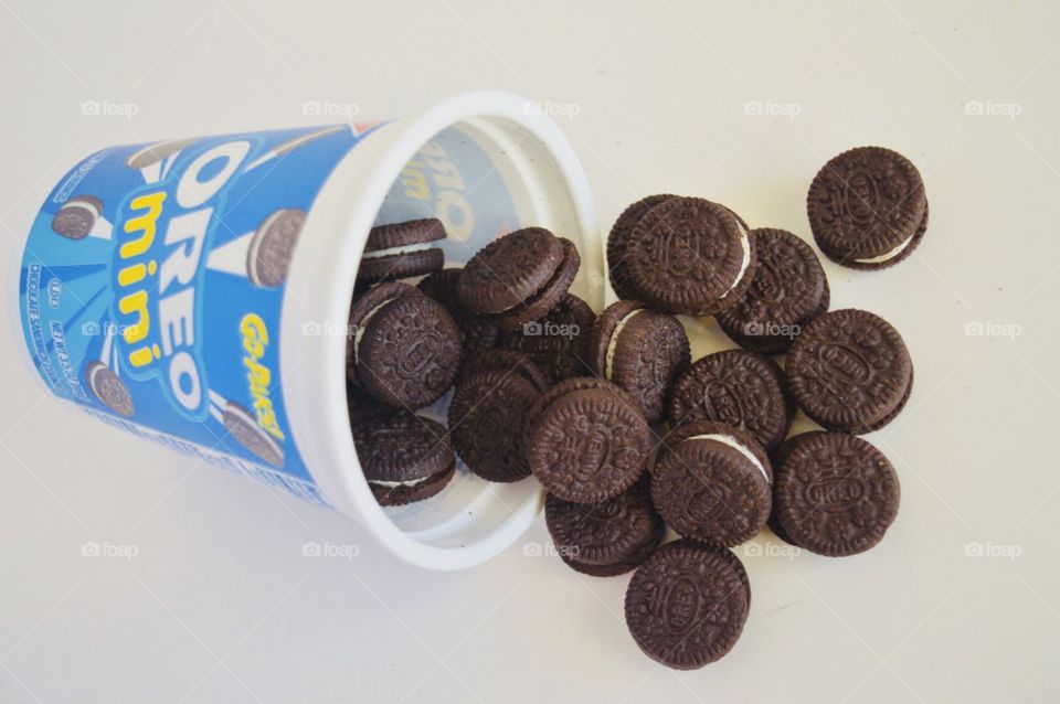 Oreo mini cookies go pack open container with spilled cookies 