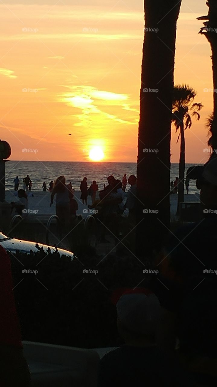 Beachgoers enjoying Spring sunset at Clearwater Beach, FL