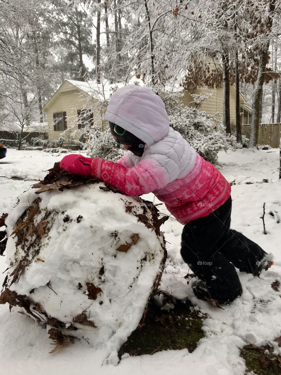 Building a snowman on an unraked yard
