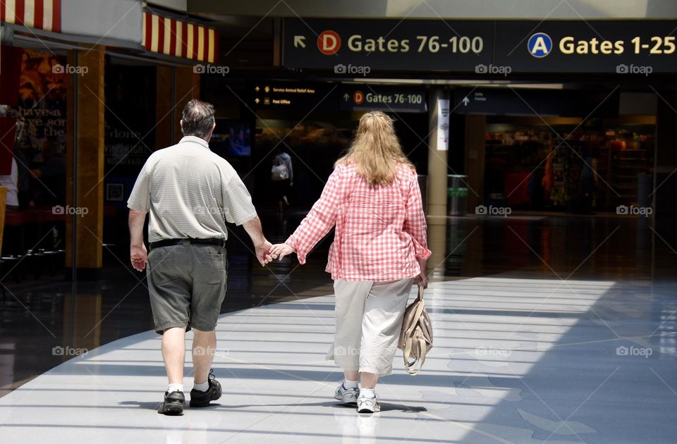 Could holding hands while walking through the airport 