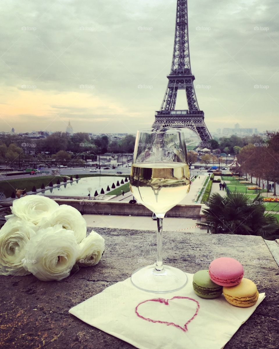 Wine glasses with croissant on the Eiffel Tower background 