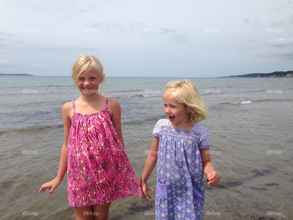 Beach. Sisters enjoying spring