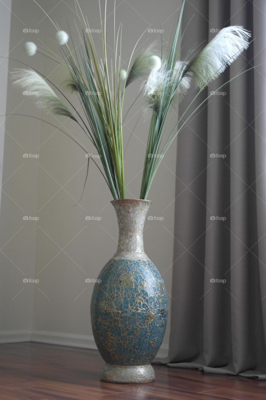 Vase with fake nails on the floor 