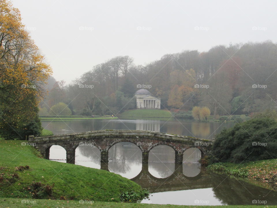 A bridge at stourhead with reflection on the lake
