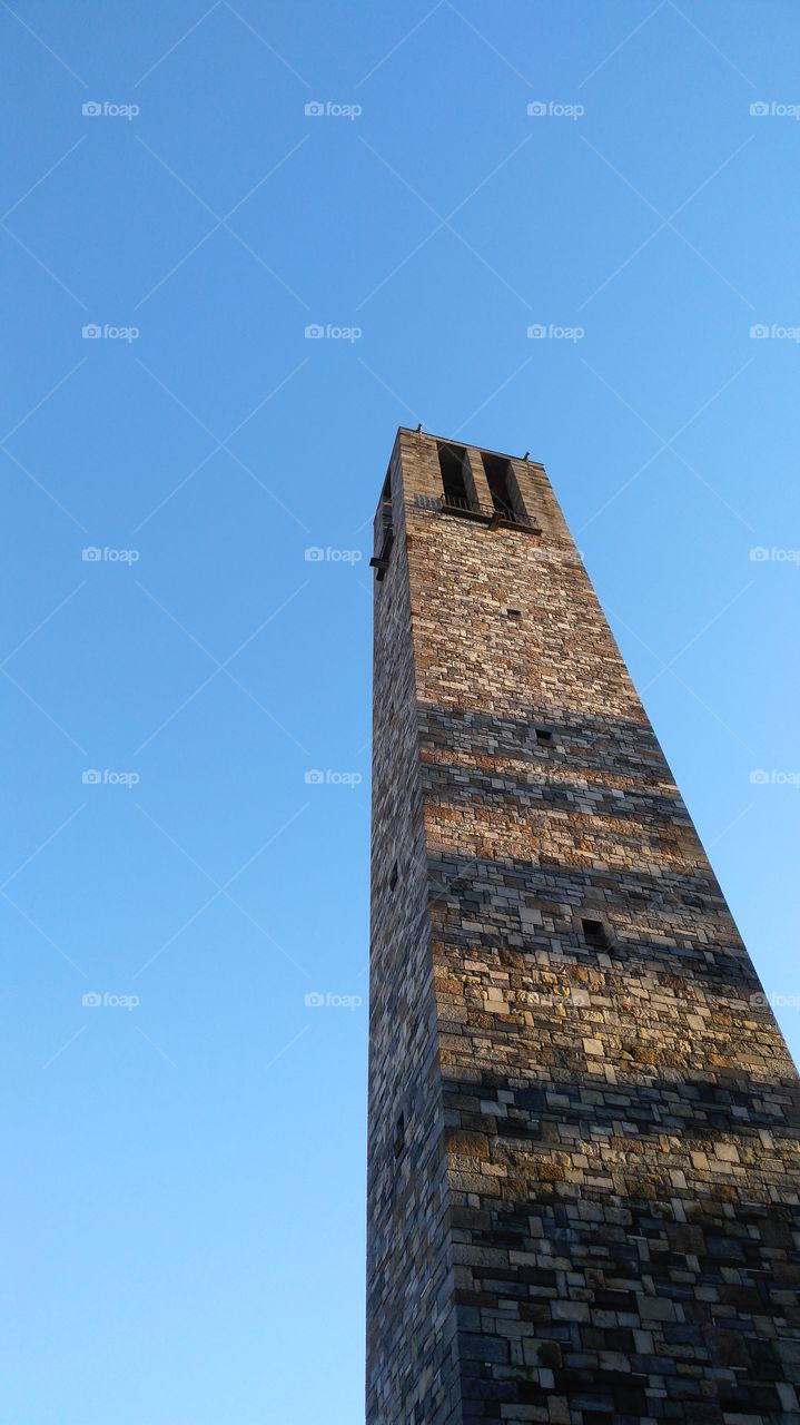 bricks bell tower with blue sky in the background