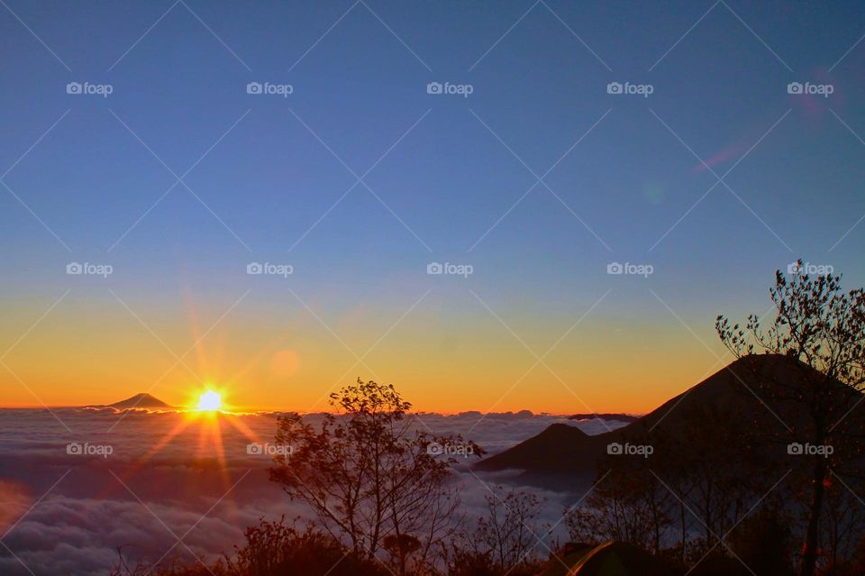Panoramic view of Sea of clouds on colorful sunset in the mountains.