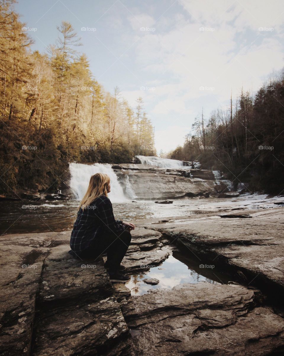 a woman watch the small waterfall