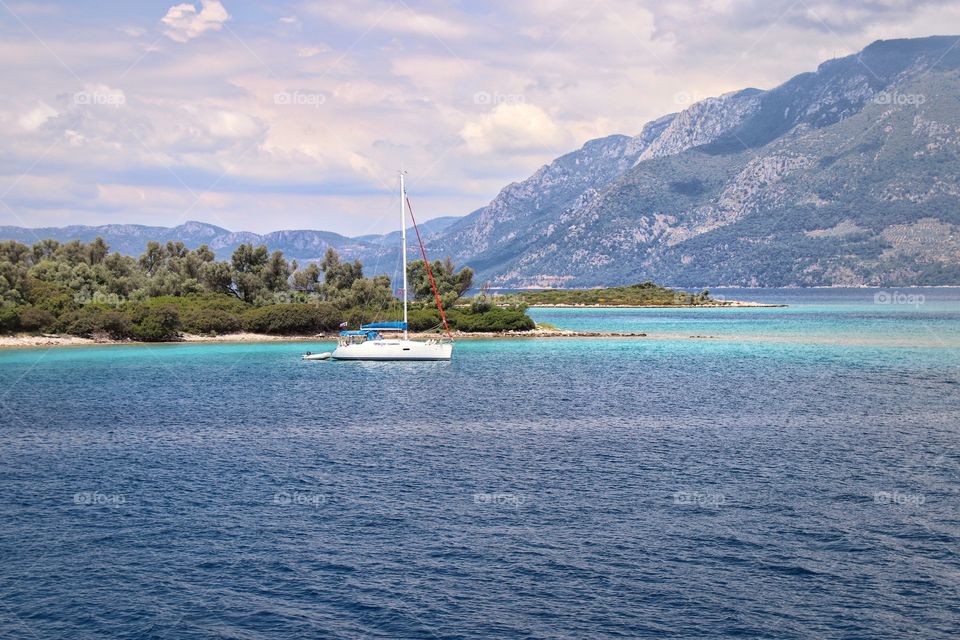 Boat on blue sea island green