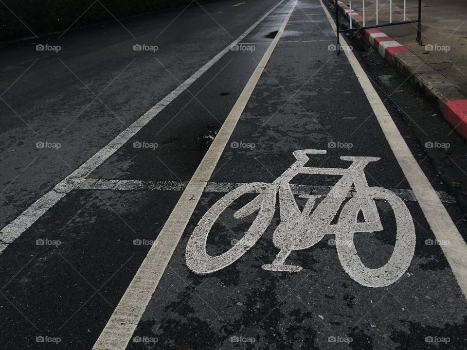 Bicycle path drawn on the asphalt road. Lanes for cyclists