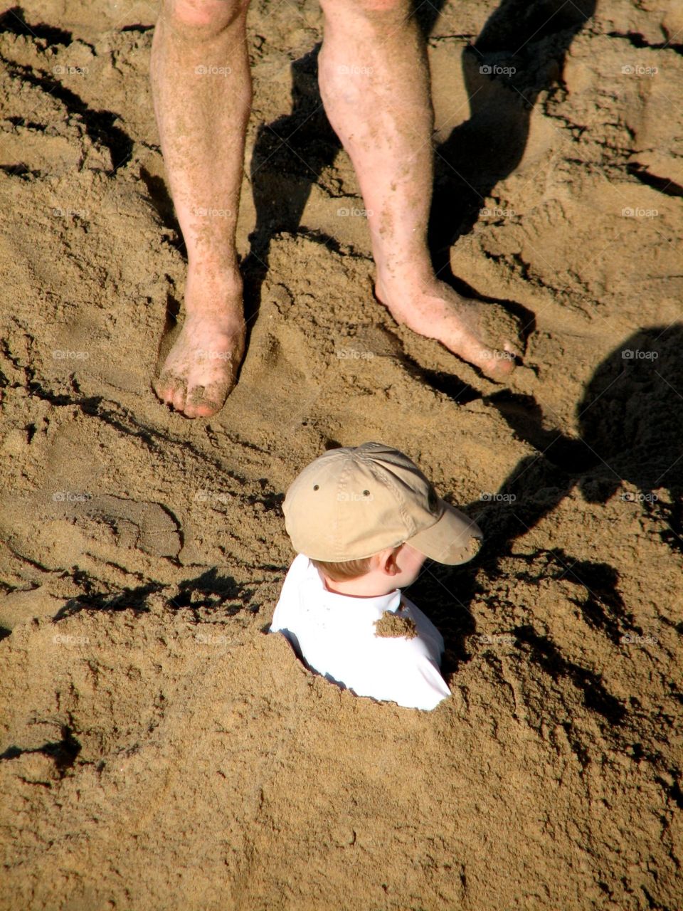 Child buried in the sand. Child buried in the sand at Manhattan Beach, CA