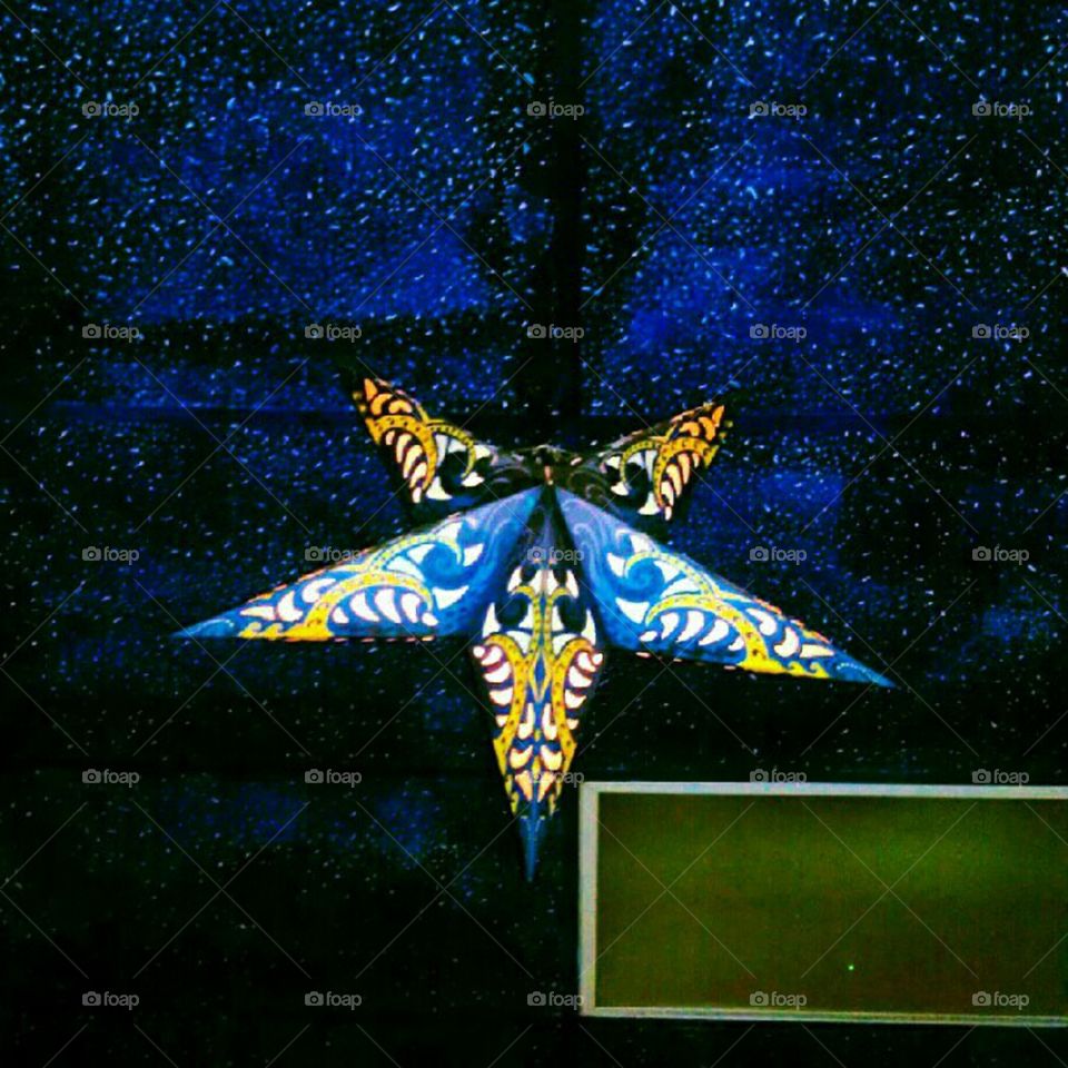 Star decoration hanging from ceiling at Hookah Lounge