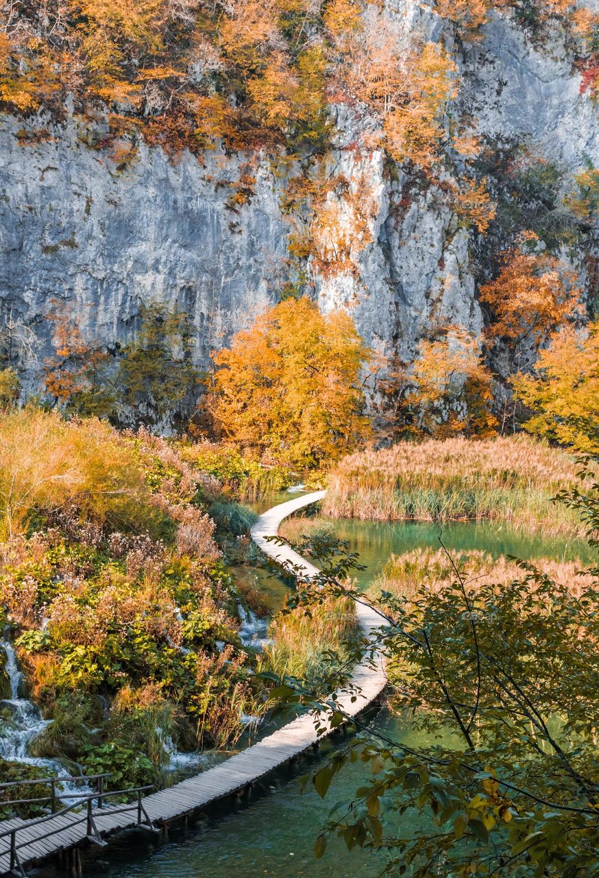Wooden pathway across lake at Plitvice lakes national park in Croatia in autumn