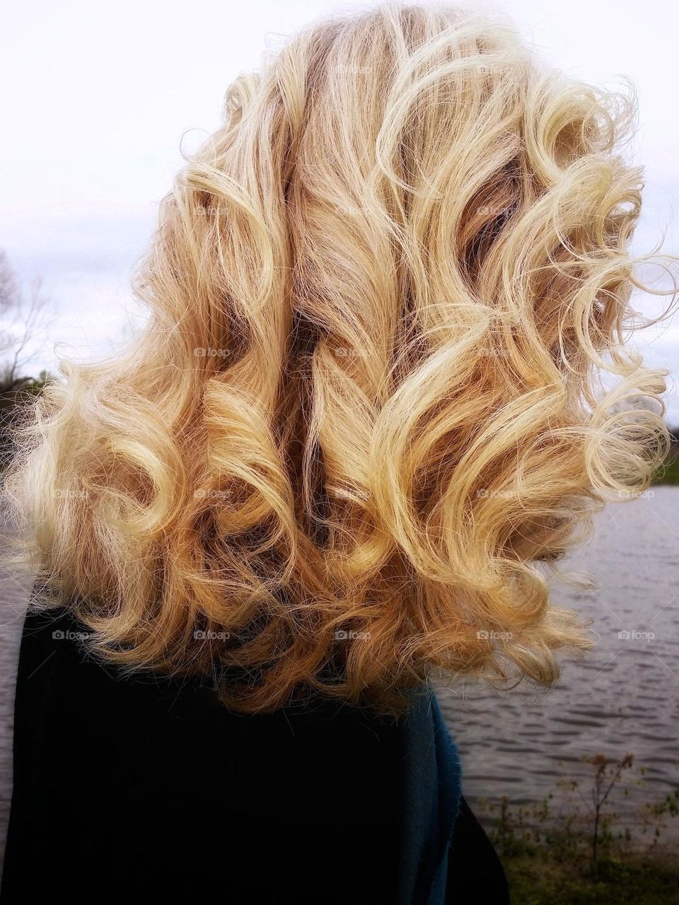 Woman with Blond curly hair from the back