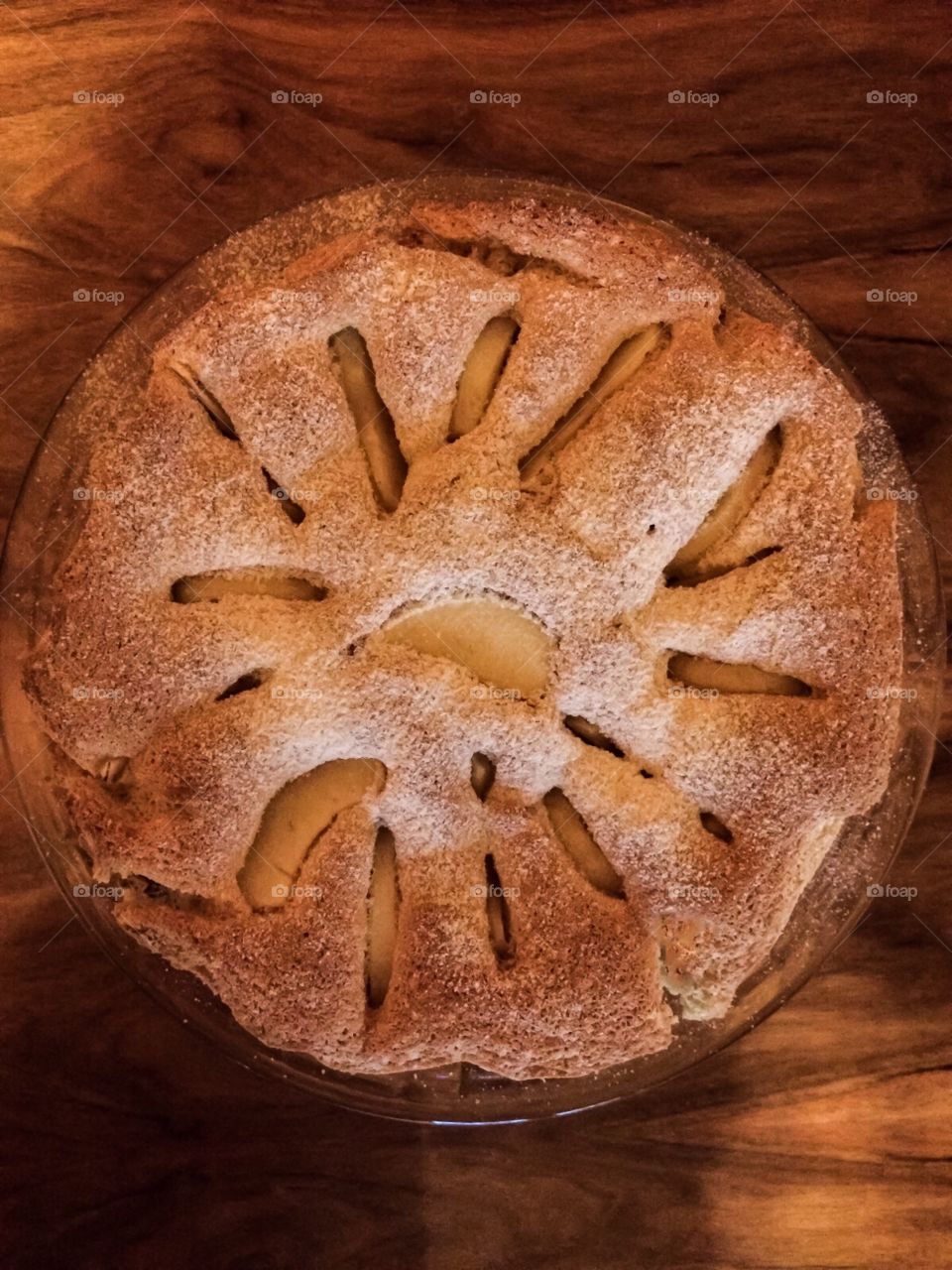 Round sponge cake on the wooden table 