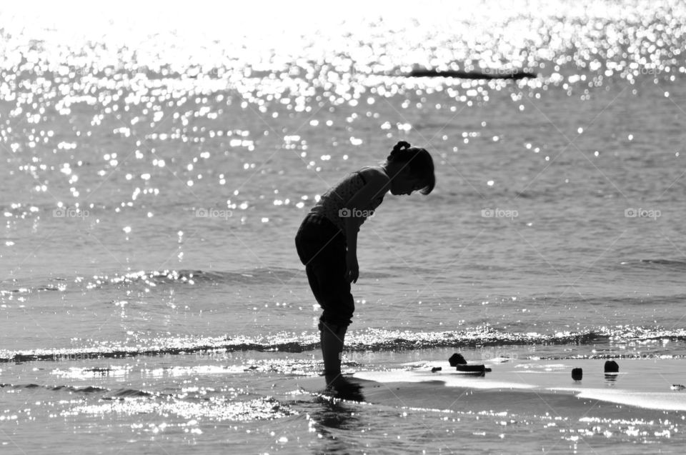 Girl is playing sand on the beach