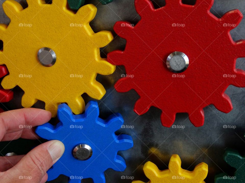 Hands Assembling A Puzzle