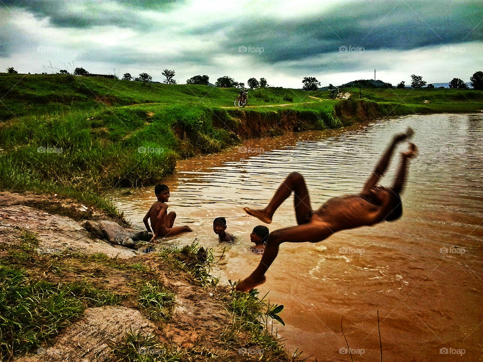 Boys jumping on water