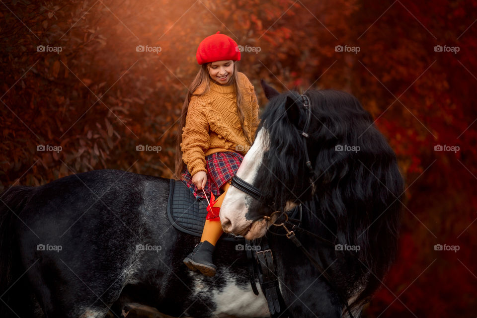 Twins girls with black claydasdale stallion 