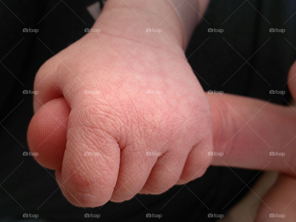 Firm Grip. The firm grip of a babys hand.