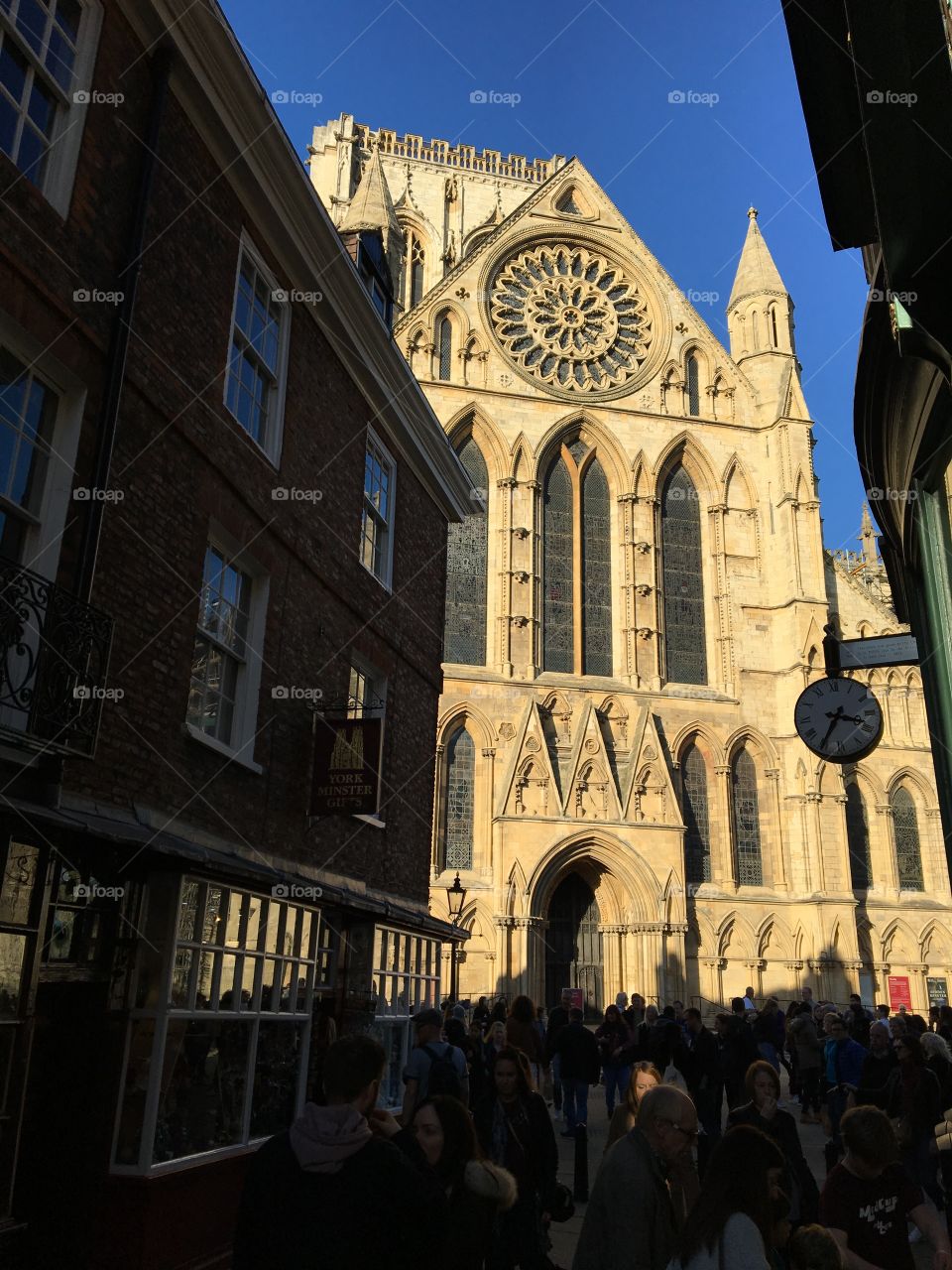 Beautiful York Minster a favourite building of mine in York ... I love this photo as it shows a bright blue sky contrasting with the Minster stone and a small ray of sunshine lighting up a face in the crowded street 