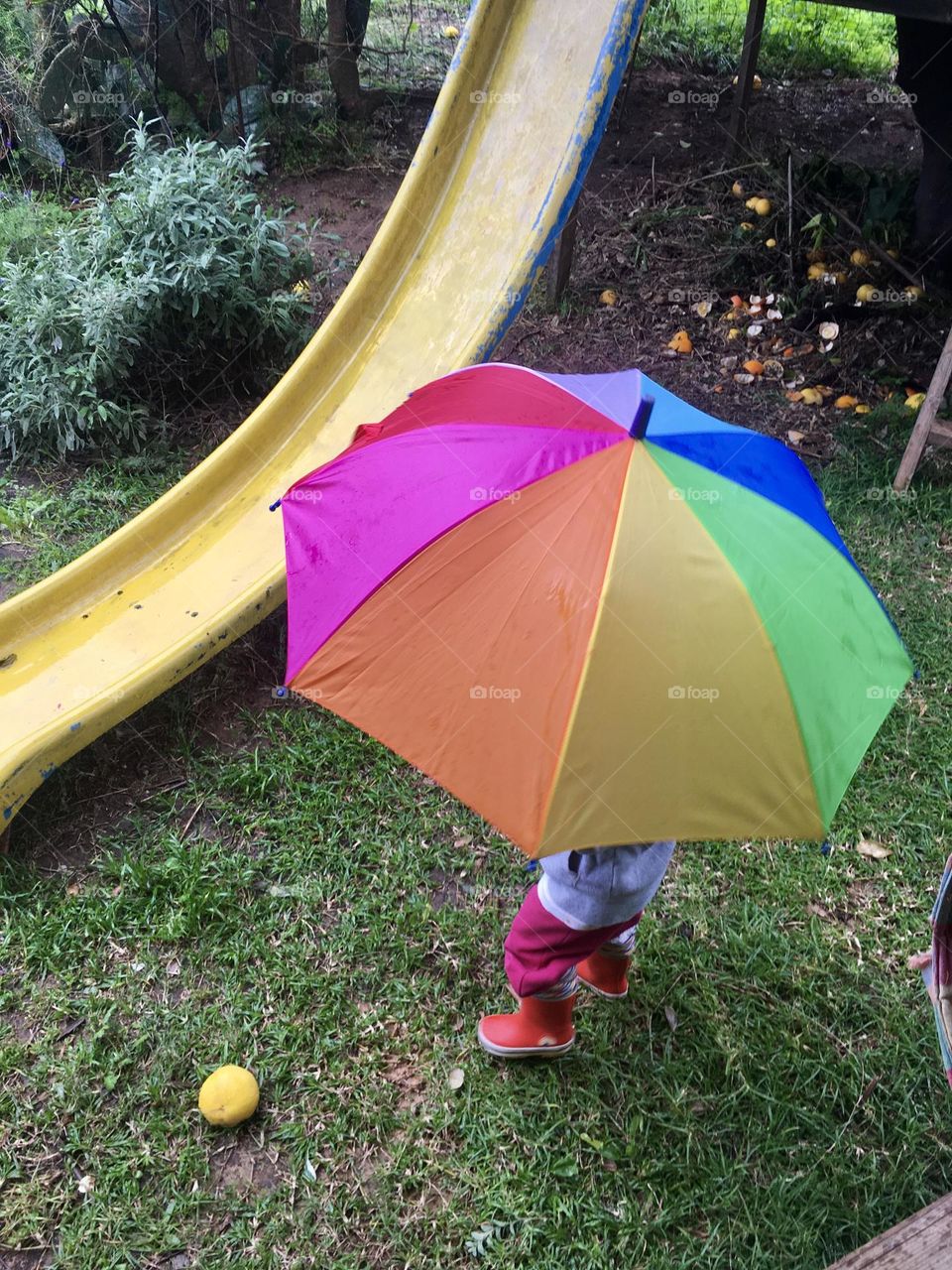 Girl with rainbow umbrella view from above 