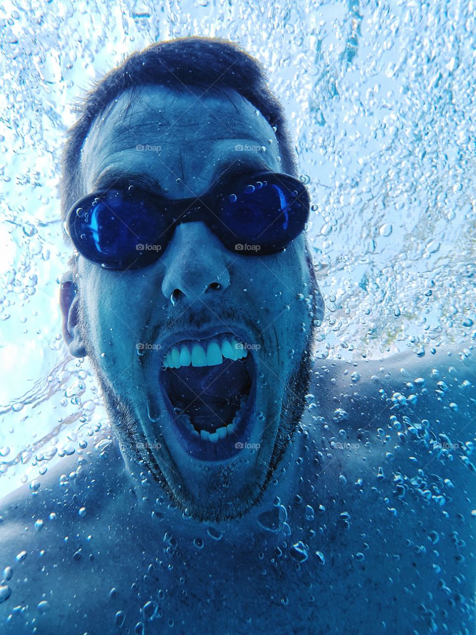 Man with underwater goggles screaming