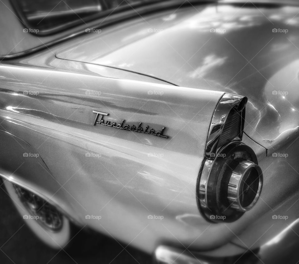 Black and white car fender. A black and white shot of a ford thunderbird on a sunny day