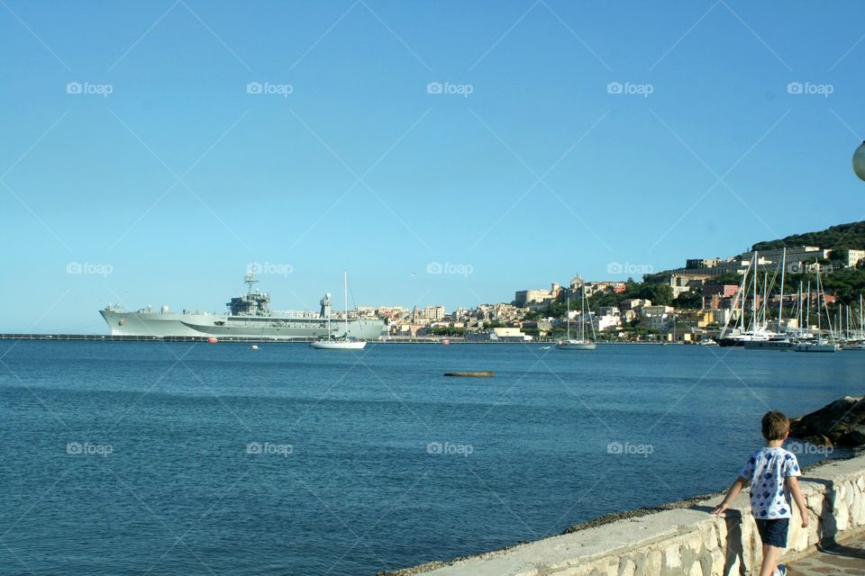 Kid looking military ship