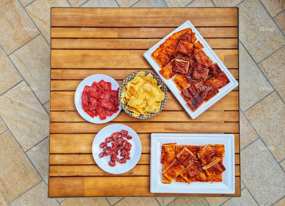 flat lay of small table with aperitif and snacks