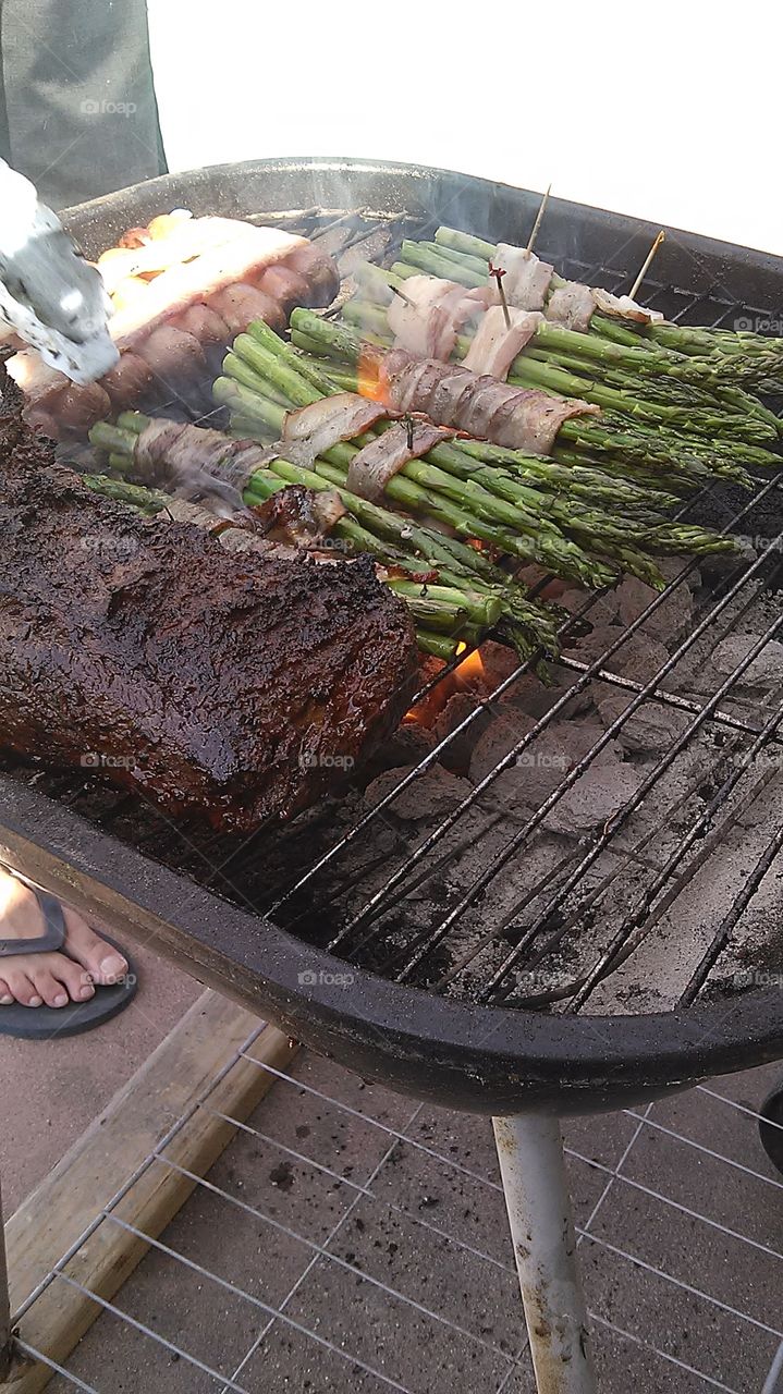 Meat and vegetables. Some friends having a BBQ out by the pool
