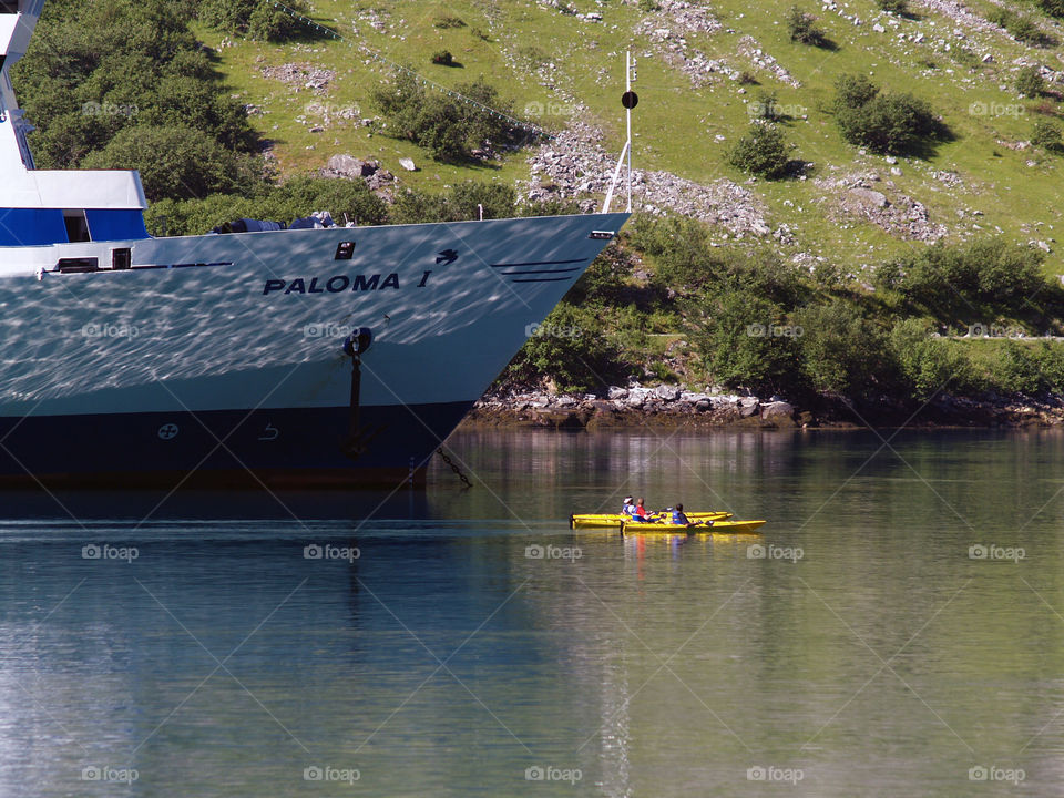 giant ship and kayaks