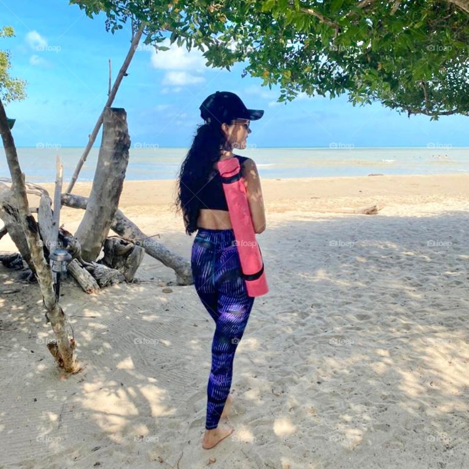 A woman practicing yoga in the beach in La Guajira Colombia
