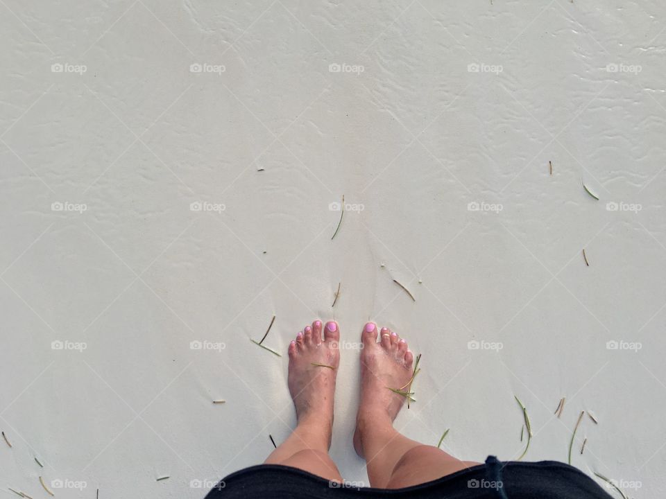 Barefoot on the beach.