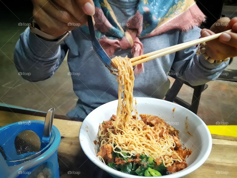 Eating delicious noodle.