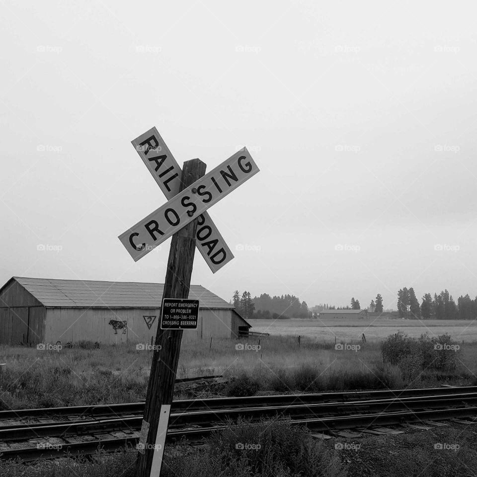 Railroad crossing sign in black and white