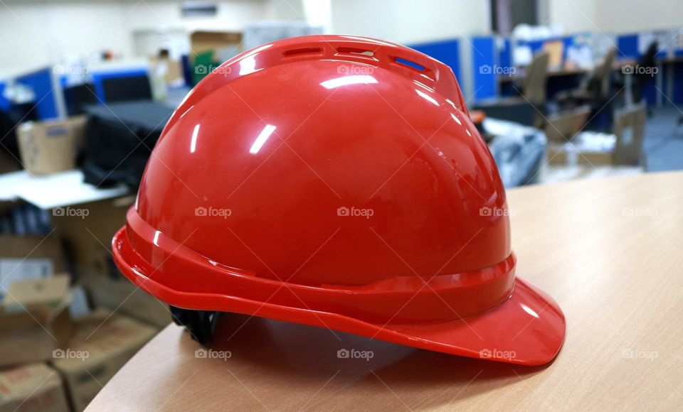 Photo of a red safety helmet, this photo has a white background