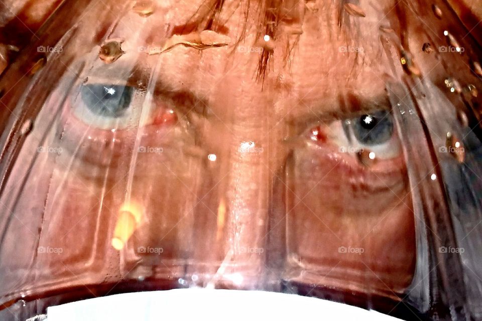 eyes looking through bottle