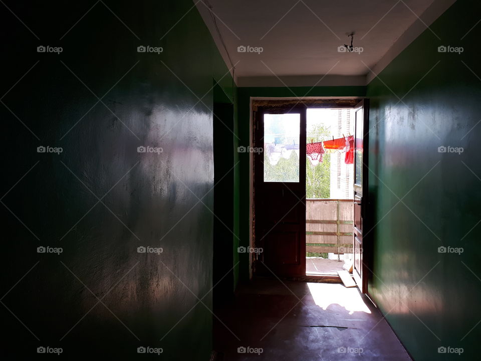 Corridor to the balcony with drying clothes