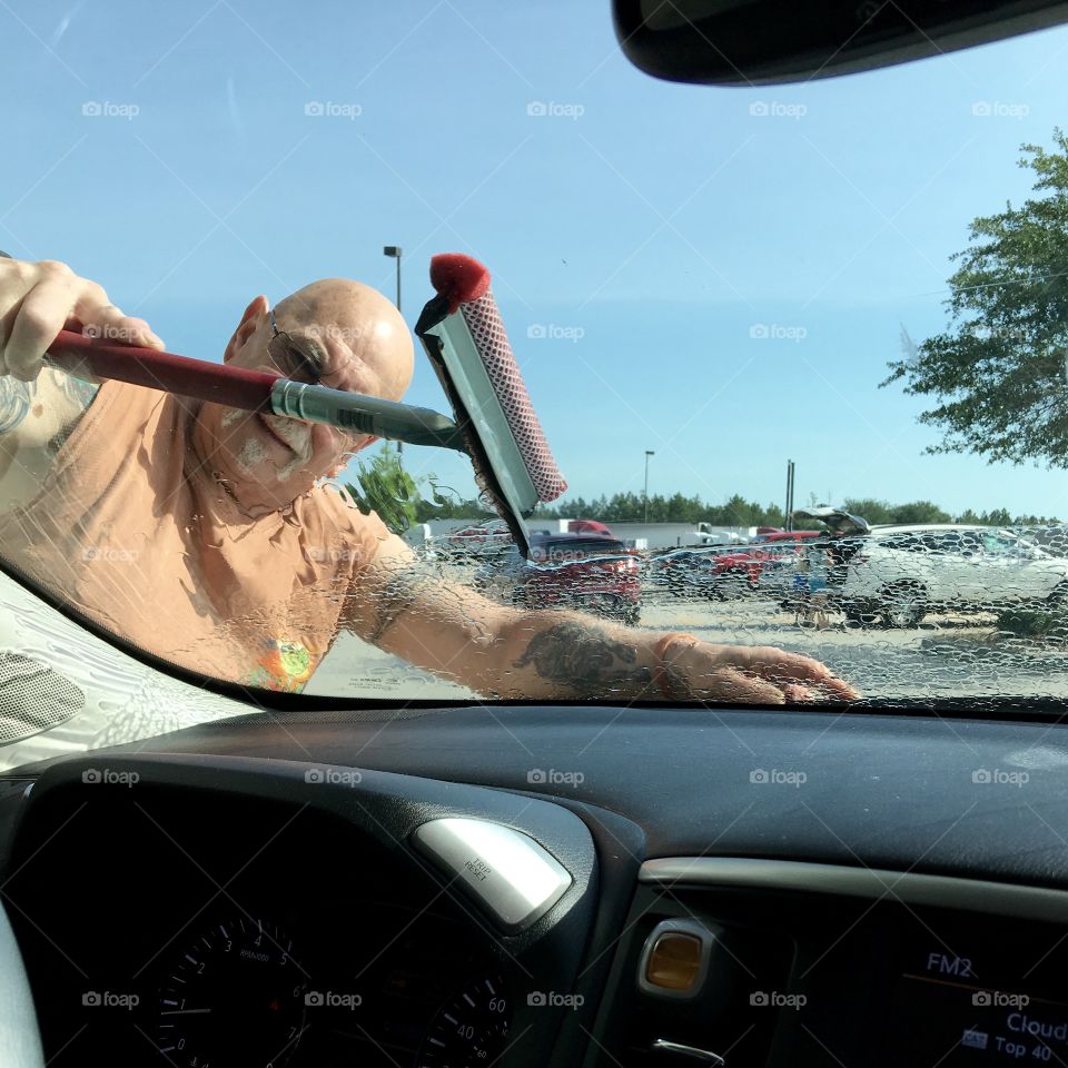 Washing windshield at gas station!
