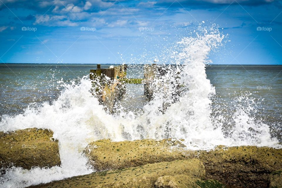 Waves crashing on rocks on beach 