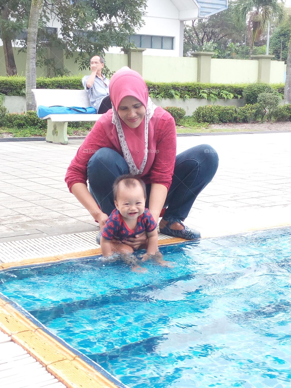 You're cute baby and nice smile . My Mother and with her grandchild , it's so happy family . We're at our big family swimming pool. Enjoy the day!