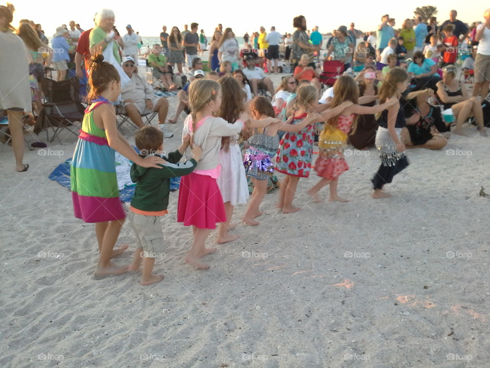 Do the locomotion. children doing the locomotion in the sand at Nokomis beach drum circle