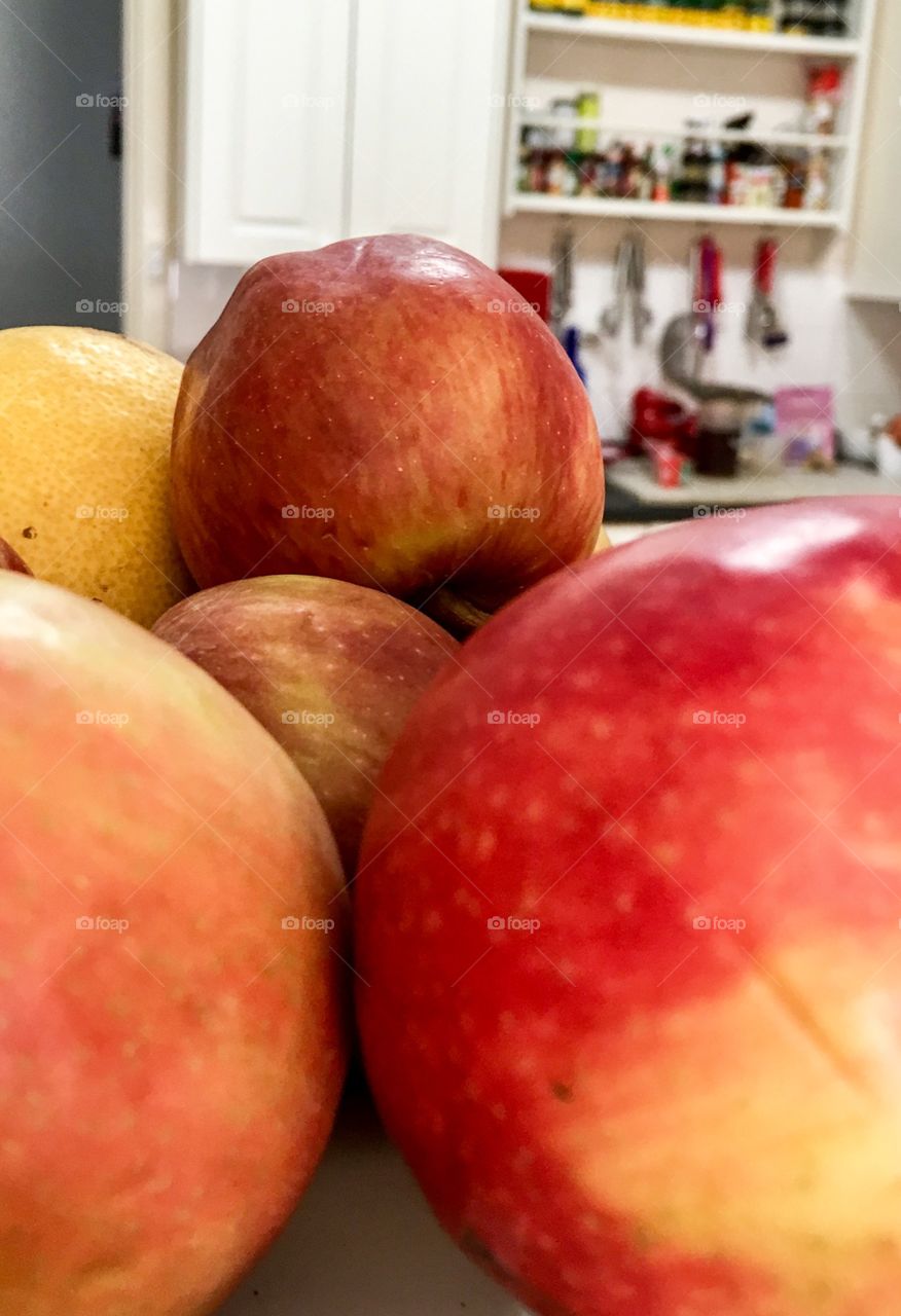 Red apples indoor closeup kitchen in blurred background 