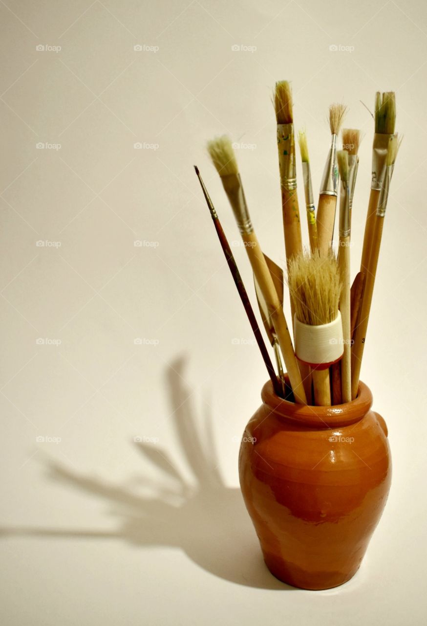shadow of hold paint brushes