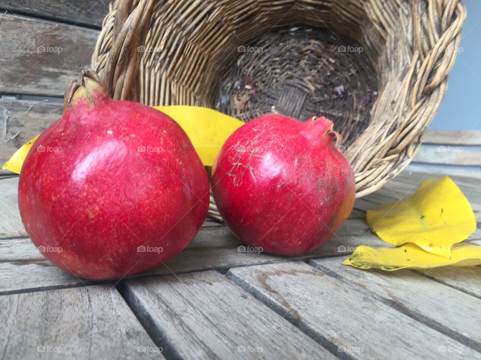 two pomegranates and a basket