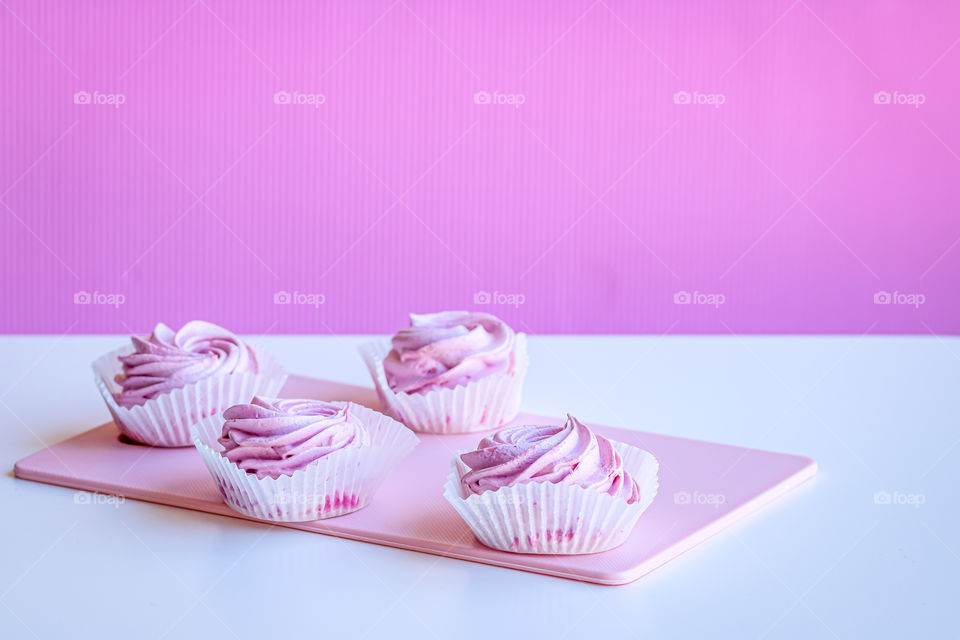 Selective focus to pink fruits marshmallow  on white table and pink background.