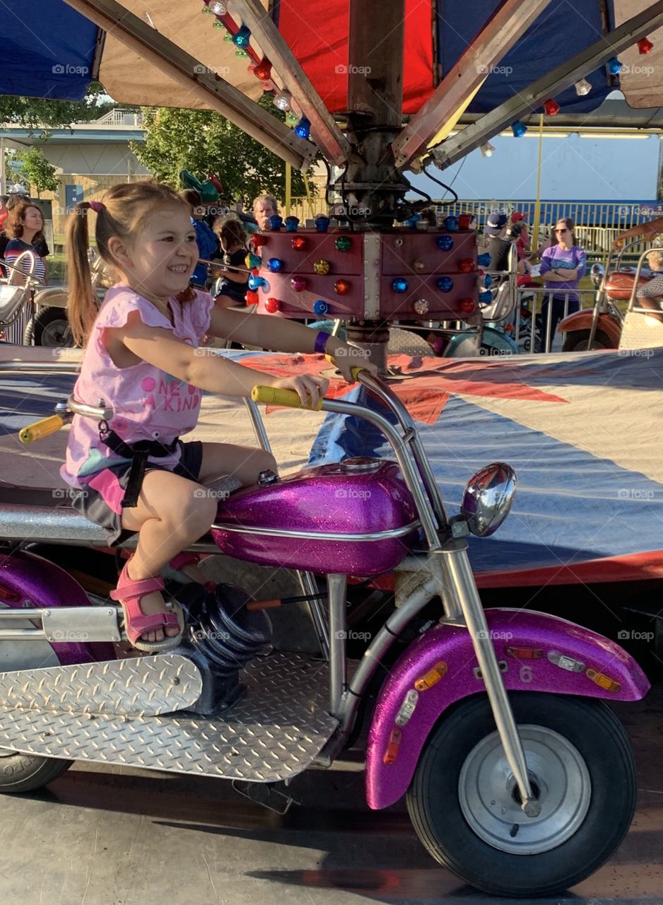 Riding A Motorcycle At The Carnival 