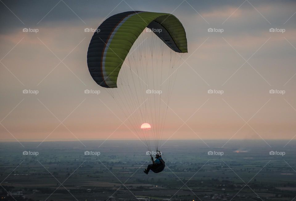Paragliding flight on the sun