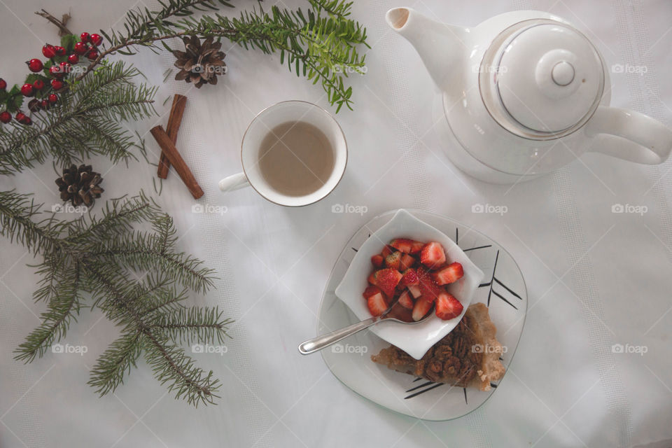 Tea, strawberries and pecan pie in a festive flat lay.