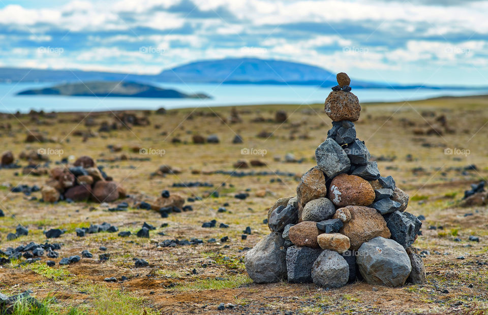 Pyramid of stones on the shore of the lake